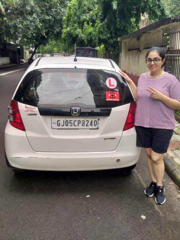 onfident college girl Sarah Modi sitting in her car after overcoming driving fear in Surat